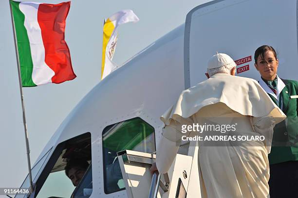 Pope Benedict XVI walks up the gangway as he boards his personal airplane upon leaving Rome's Ciampino military Airport to fly to the Czech Republic,...