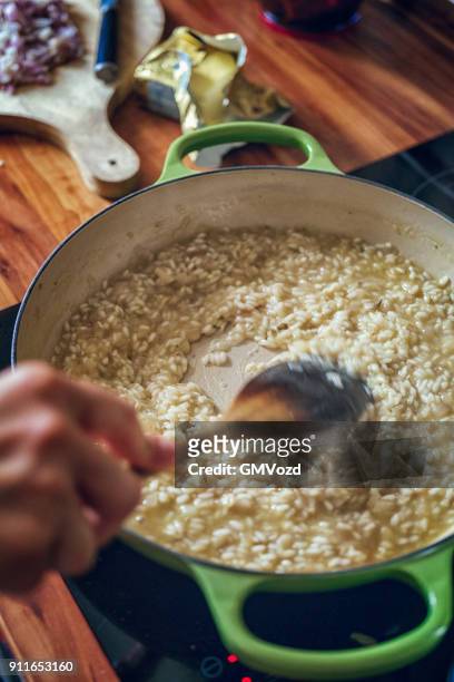 preparing risotto bianco served with parmesan - risotto stock pictures, royalty-free photos & images