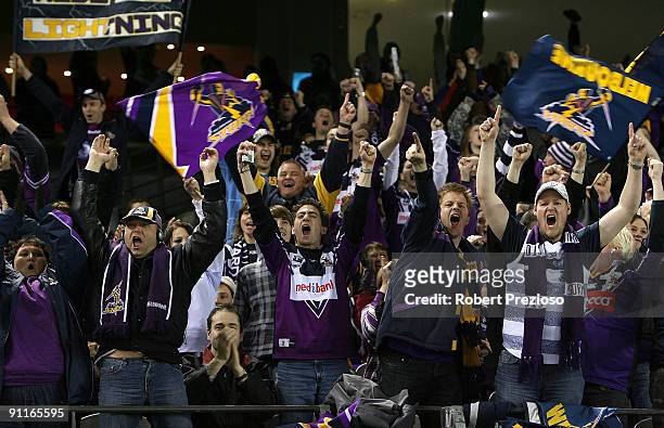 Storm fans celebrate a try during the second NRL Preliminary Final match between the Melbourne Storm and the Brisbane Broncos at Etihad Stadium on...