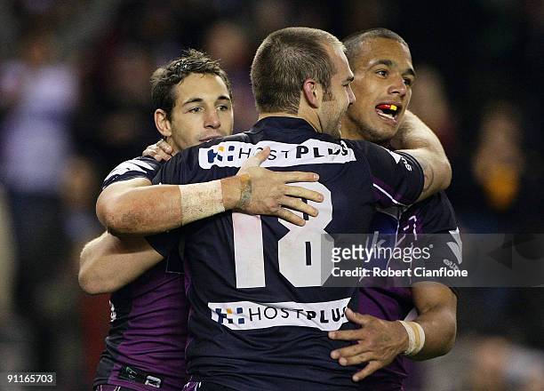 Billy Slater of the Storm celebrates a try with Scott Anderson and Will Chambers during the second NRL Preliminary Final match between the Melbourne...