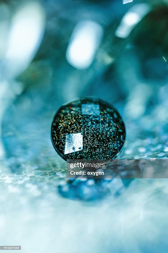 Crystal button on aqua bokeh background