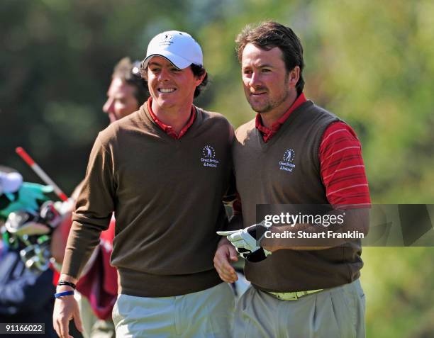 Rory McIlroy and Graeme McDowell of the Great Britian and Northern Ireland team look happy on the 16th hole during the third day morning greensomes...