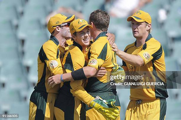 Australian bowler Peter Siddle and Australian wicket keeper Tim Paine celebrate the wicket of West Indies batsman Devon Smith on September 26, 2009...