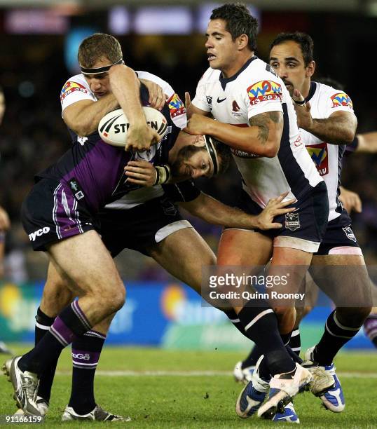 Dallas Johnson of the Storm is tackled during the second NRL Preliminary Final match between the Melbourne Storm and the Brisbane Broncos at Etihad...