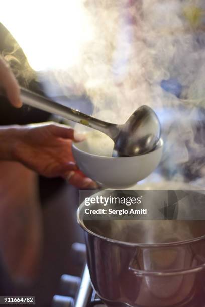 serving tortellini into a bowl using a ladle - cucharón fotografías e imágenes de stock