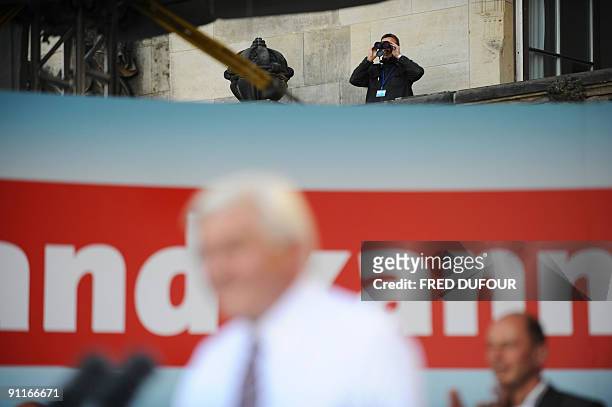Policeman watches supporters during the speech of German Foreign Minister and the Social Democrats party main candidate Frank-Walter Steinmeier at...