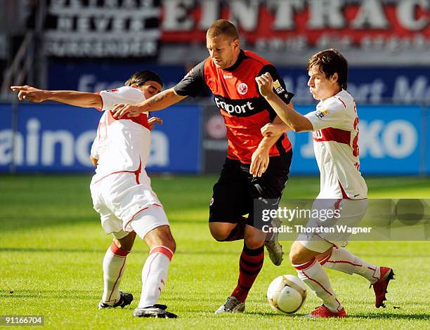 Marco Russ of Frankfurt battles for the ball with Sami Khedira and Stefano Celozzi of Stuttgart during the Bundesliga match between Eintracht...
