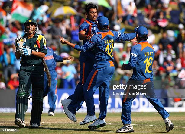 Singh of India celebrates with teammates after taking the wicket of Younis Khan of Pakistan during the ICC Champions Trophy group A match between...