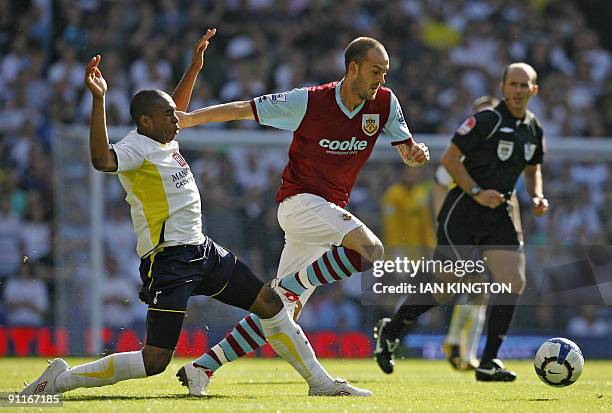 Burnley's Scottish player Steven Fletcher vies with Tottenham Hotspur's Honduran player Wilson Palacios during the English Premier League football...