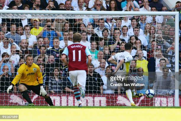 Robbie Keane of Tottenham Hotspur sends goalkeeper Brian Jensen of Burnley the wrong way to score the first goal of the match from the penalty spot...