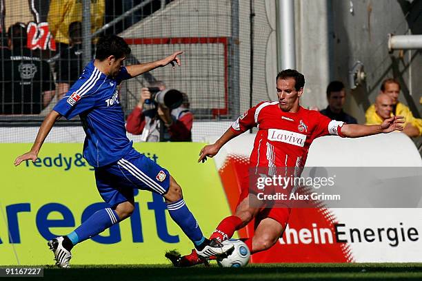 Petit of Koeln is challenged by Arturo Vidal of Leverkusen during the Bundesliga match between 1. FC Koeln and Bayer Leverkusen at the Rhein Energie...