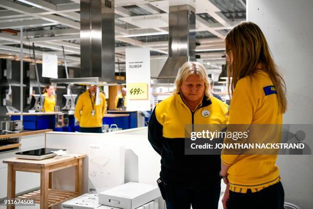 Employees stand during a minute of silence in honour of Ingvar Kamprad, founder of the Swedish furniture giant IKEA, on January 29, 2018 in Barkaby,...
