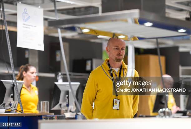 Employees stand during a minute of silence in honour of Ingvar Kamprad, founder of the Swedish furniture giant IKEA, on January 29, 2018 in Barkaby,...