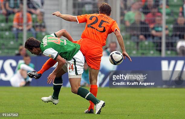 Philipp Bargfrede of Bremen and Andreas Ivanschitz of Mainz fight for the ball during the Bundesliga match between SV Werder Bremen and FSV Mainz 05...