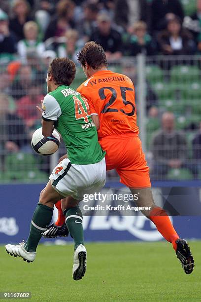 Philipp Bargfrede of Bremen and Andreas Ivanschitz of Mainz fight for the ball during the Bundesliga match between SV Werder Bremen and FSV Mainz 05...