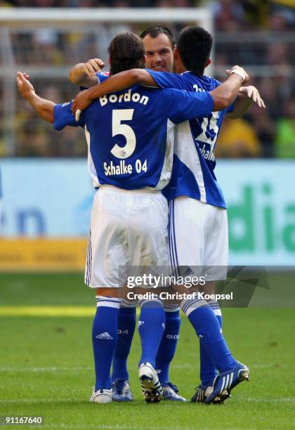 Heiko Westermann of Schalke celebrates scoring his team's first goal with team mates Marcelo Bordon and Carlos Zambrano during the Bundesliga match...