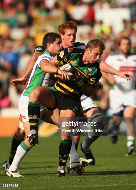 Roger Wilson of Northampton Saints is tackled by Henry Paul of Leeds during the Guinness Premiership match between Northampton Saints and Leeds...
