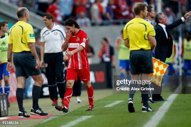Maniche of Koeln leaves the pitch after being sent off by referee Michael Kempter during the Bundesliga match between 1. FC Koeln and Bayer...