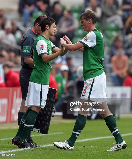 Mesut Oezil and Tim Borowski of Bremen shake hands during the Bundesliga match between SV Werder Bremen and FSV Mainz 05 at Weser Stadium on...