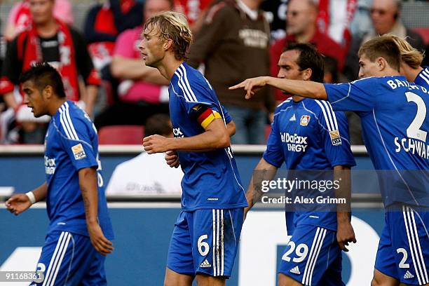 Simon Rolfes of Leverkusen celebrates his team's first goal with team mates Arturo Vidal Theofanis Gekas and Daniel Schwaab during the Bundesliga...