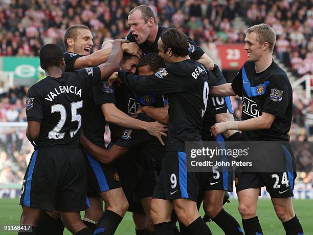 John O'Shea of Manchester United celebrates scoring their second goal during the Barclays FA Premier League match between Stoke CIty and Manchester...