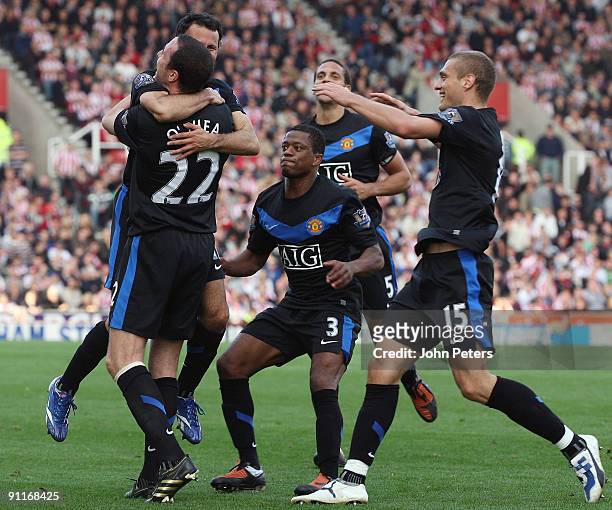 John O'Shea of Manchester United celebrates scoring their second goal during the Barclays FA Premier League match between Stoke CIty and Manchester...