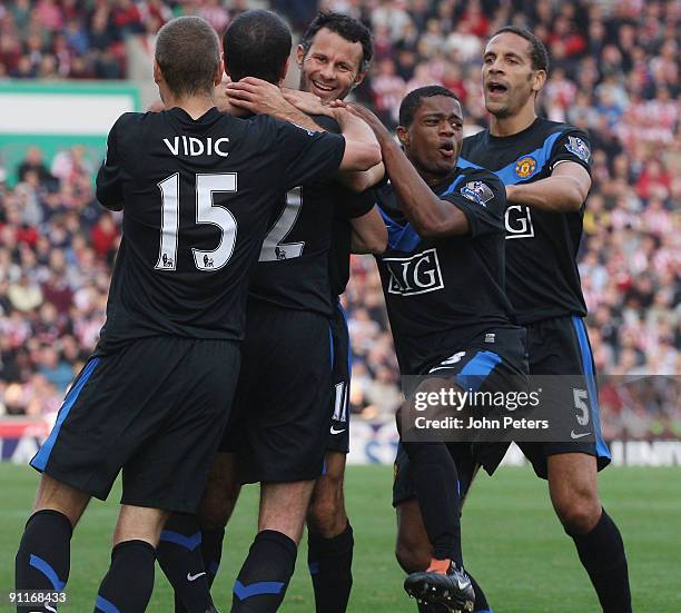 John O'Shea of Manchester United celebrates scoring their second goal during the Barclays FA Premier League match between Stoke CIty and Manchester...