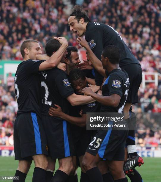 John O'Shea of Manchester United celebrates scoring their second goal during the Barclays FA Premier League match between Stoke CIty and Manchester...