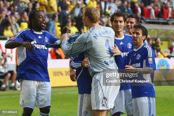 Gerald Asamoah, Manuel Neuer, Halil Altintop and Vicente Sanchez of Schalke celebrate the 1-0 victory after the Bundesliga match between Borussia...