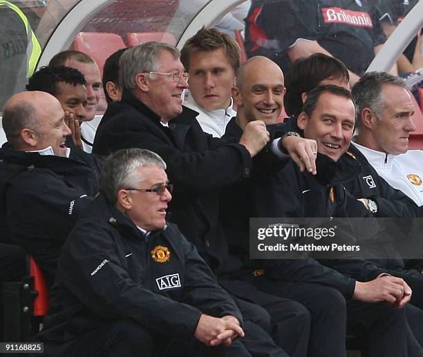 Sir Alex Ferguson of Manchester United shows his watch to the crowd after chants of "Fergie Fergie what's the time?" during the Barclays FA Premier...