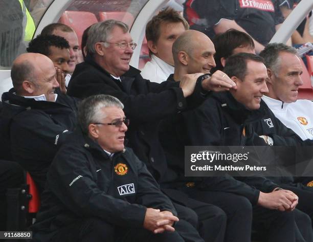 Sir Alex Ferguson of Manchester United shows his watch to the crowd after chants of "Fergie Fergie what's the time?" during the Barclays FA Premier...