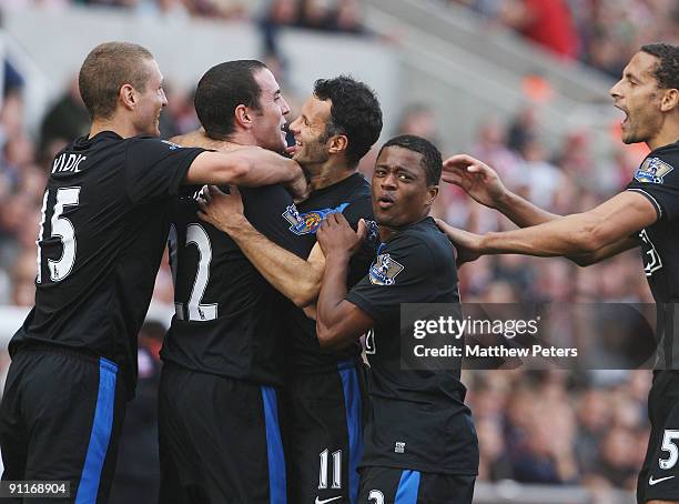 John O'Shea of Manchester United celebrates scoring their second goal during the Barclays FA Premier League match between Stoke CIty and Manchester...