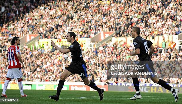 Manchester United's Irish player John O'Shea celebrates after scoring the second goal during the English Premier League football match between Stoke...