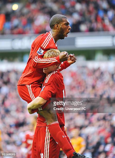 Ryan Babel of Liverpool celebrates with team mate Dirk Kuyt after scoring a goal to make it 5-1 during the Barclays Premier League match between...