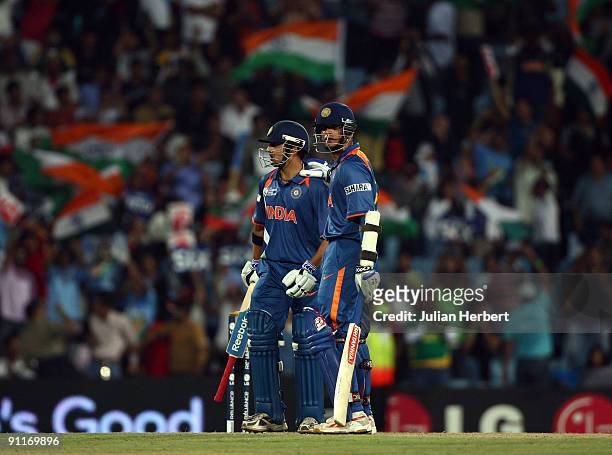Gautam Gambir of India is congratulated by team mate Raul Dravid on his 50 during The ICC Champions Trophy Group A Match between India and Pakistan...