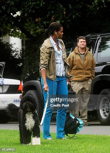 First Lady Michelle Obama walks the family dog Bo, on the South Lawn of the White House on September 26, 2009 in Washington D.C. Obama had just...