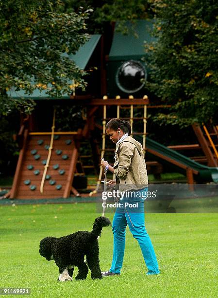 First Lady Michelle Obama walks the family dog Bo, on the South Lawn of the White House on September 26, 2009 in Washington D.C. Obama had just...