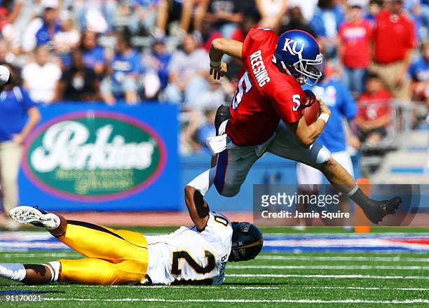 Quarterback Todd Reesing of the Kansas Jayhawks evades C.J. Bailey of the Southern Mississippi Golden Eagles during the game on September 26, 2009 at...