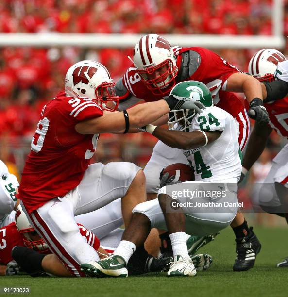 Watt and Jeff Stehle of the Wisconsin Badgers bring down Caulton Ray of the Michigan State Spartans on September 26, 2009 at Camp Randall Stadium in...