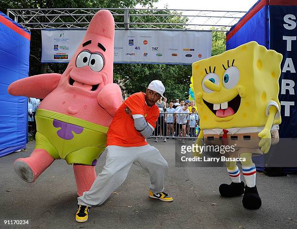 Nick Cannon poses with characters Patrick and Spongebob at Nickelodeon's Sixth Annual Worldwide Day of Play with NYC Big Brothers and Big Sisters at...