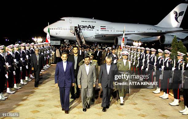 Iranian President Mahmoud Ahmadinejad is welcomed by officials at Tehran's Mehrabad Airport on September 26, 2009 upon his return from the UN General...