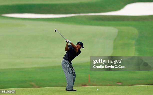 Tiger Woods plays his second shot from the ninth fairway during the third round of THE TOUR Championship presented by Coca-Cola, the final event of...