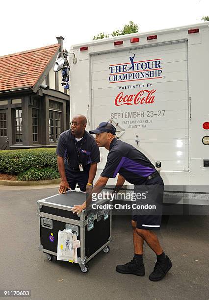 FedEx drivers deliver the FedExCup to the East Lake Golf Club during the third round of THE TOUR Championship presented by Coca-Cola, the final event...