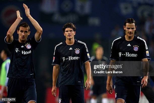 Miroslav Klose, Mario Gomez and Daniel van Buyten look dejected after loosing the Bundesliga match between Hamburger SV and FC Bayern Muenchen at HSH...