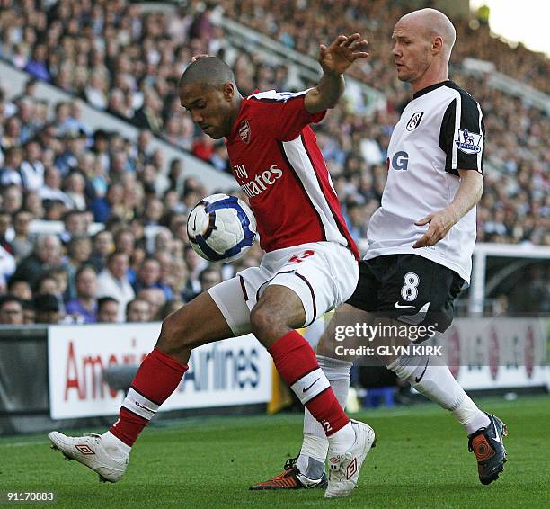 Arsenal's French defender Gael Clichy vies with Fulham's English striker Andrew Johnson during the English Premier League football match between...