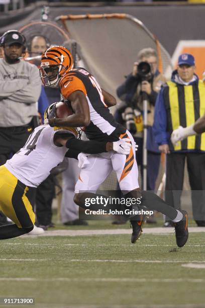 Green of the Cincinnati Bengals runs the football upfield against Coty Sensabaugh of the Pittsburgh Steelers during their game at Paul Brown Stadium...