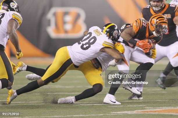 Giovani Bernard of the Cincinnati Bengals runs the football upfield against Sean Davis of the Pittsburgh Steelers during their game at Paul Brown...