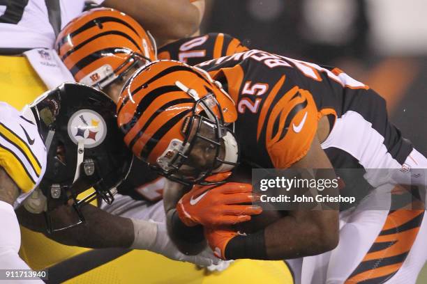 Giovani Bernard of the Cincinnati Bengals runs the football upfield against Ryan Shazier#50 of the Pittsburgh Steelers during their game at Paul...