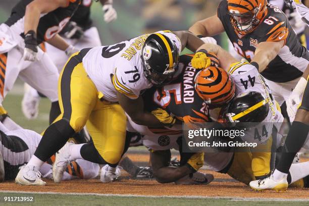 Giovani Bernard of the Cincinnati Bengals runs the football upfield against Javon Hargrave and Tyler Matakevich of the Pittsburgh Steelers during...