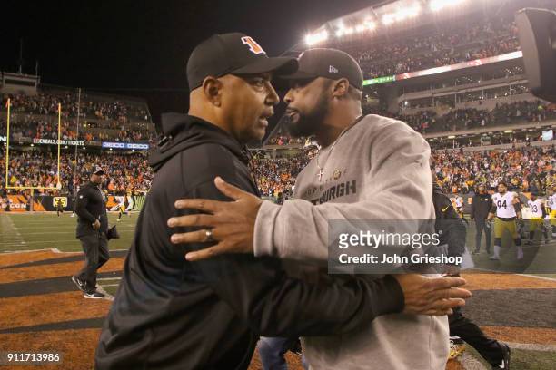 Head Coach Marvin Lewis of the Cincinnati Bengals shares a moment at midfield with Head Coach Mike Tomlin of the Pittsburgh Steelers after their game...